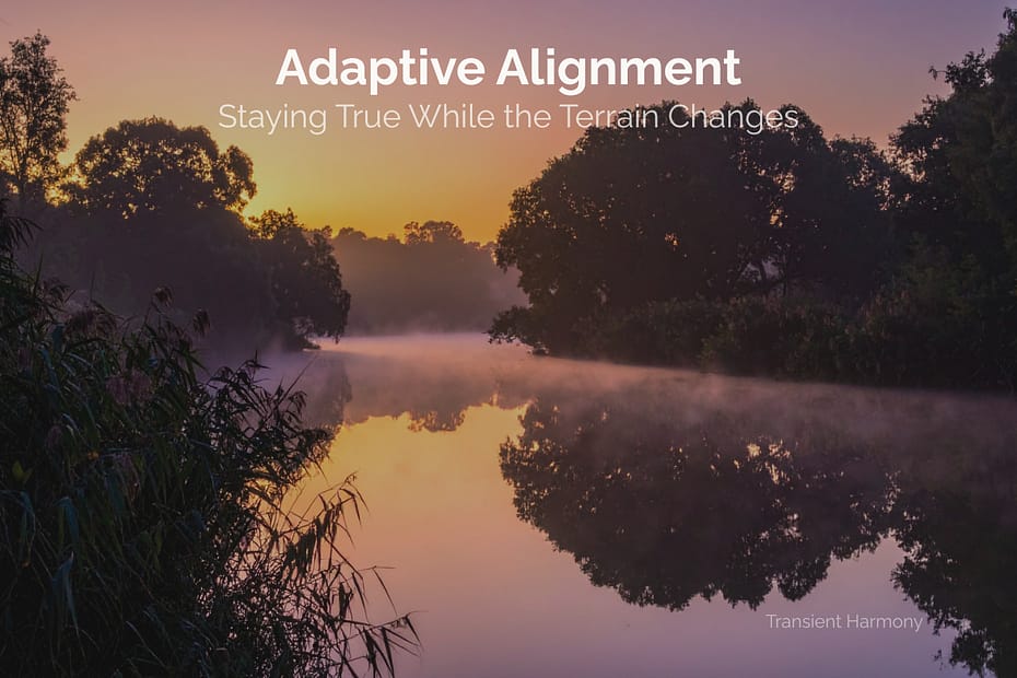 A misty river at sunrise with warm golden and purple sky reflected in still water, silhouetted trees lining both banks and reeds in the foreground, overlaid with text reading "Adaptive Alignment: Staying True While the Terrain Changes" — a Transient Harmony reflection by Braddon Damien White